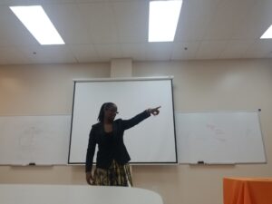 A black woman pointing at a direction