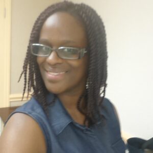 A black woman wearing her glasses
